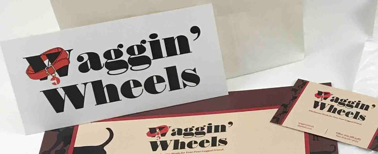Waggin' Wheels logotype with a red dog collar forming the W, beside a business card