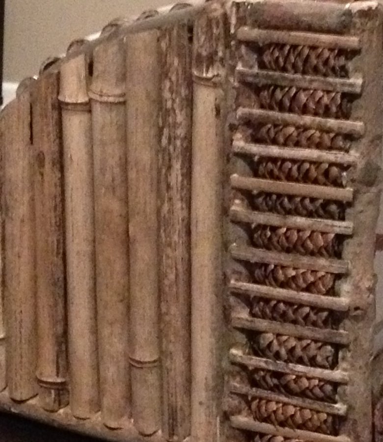 Close-up of split bamboo and the woven strip framed by small twigs