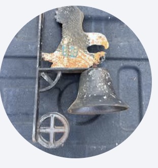 Before: cast-iron eagle bell with rust and flaking paint