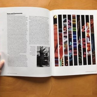 Neon and Fluorescents spread pairing a text column with vertical strips of neon photography
