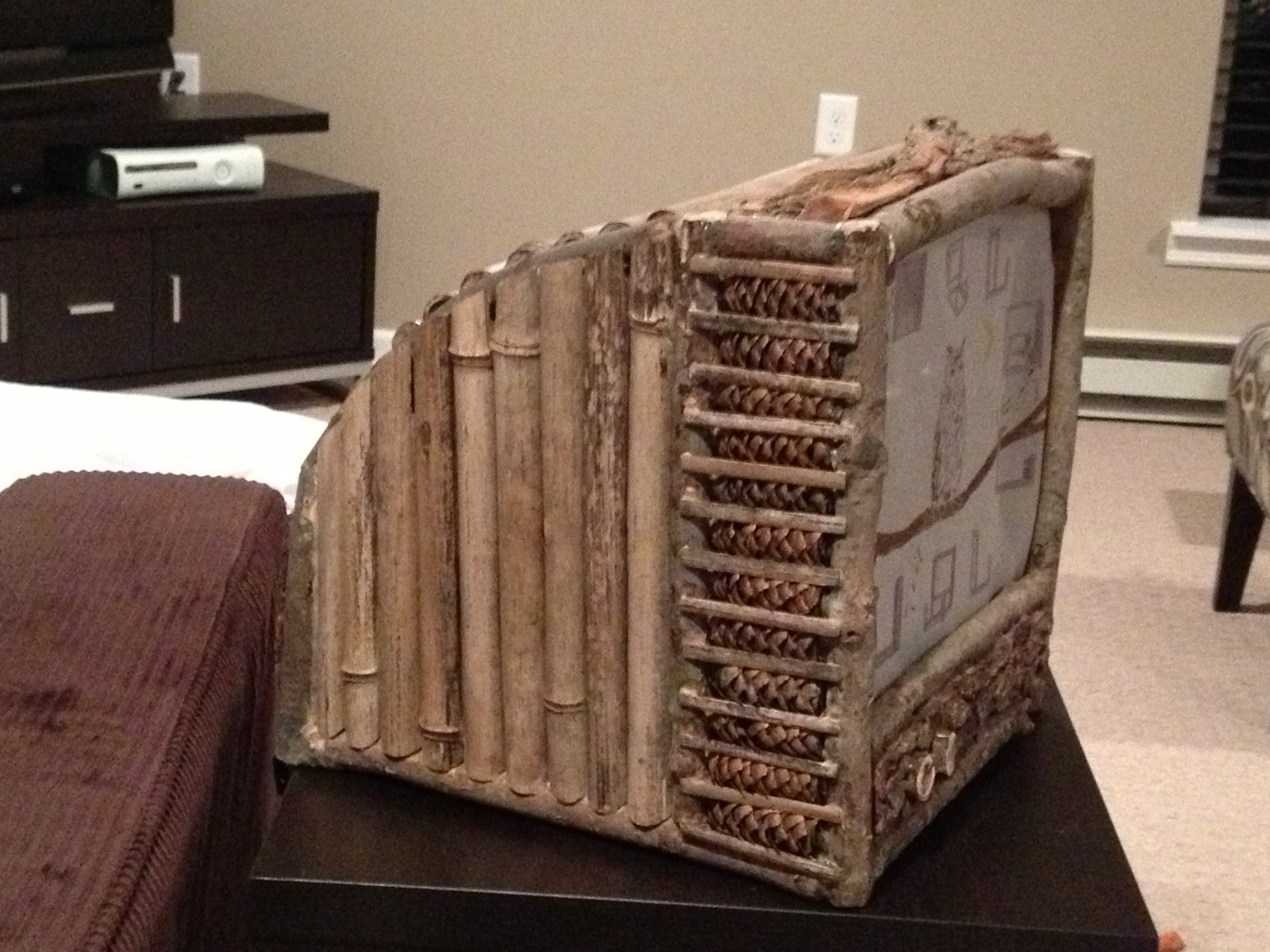 Three-quarter view showing the bamboo side panel and a strip of woven natural material beside the screen