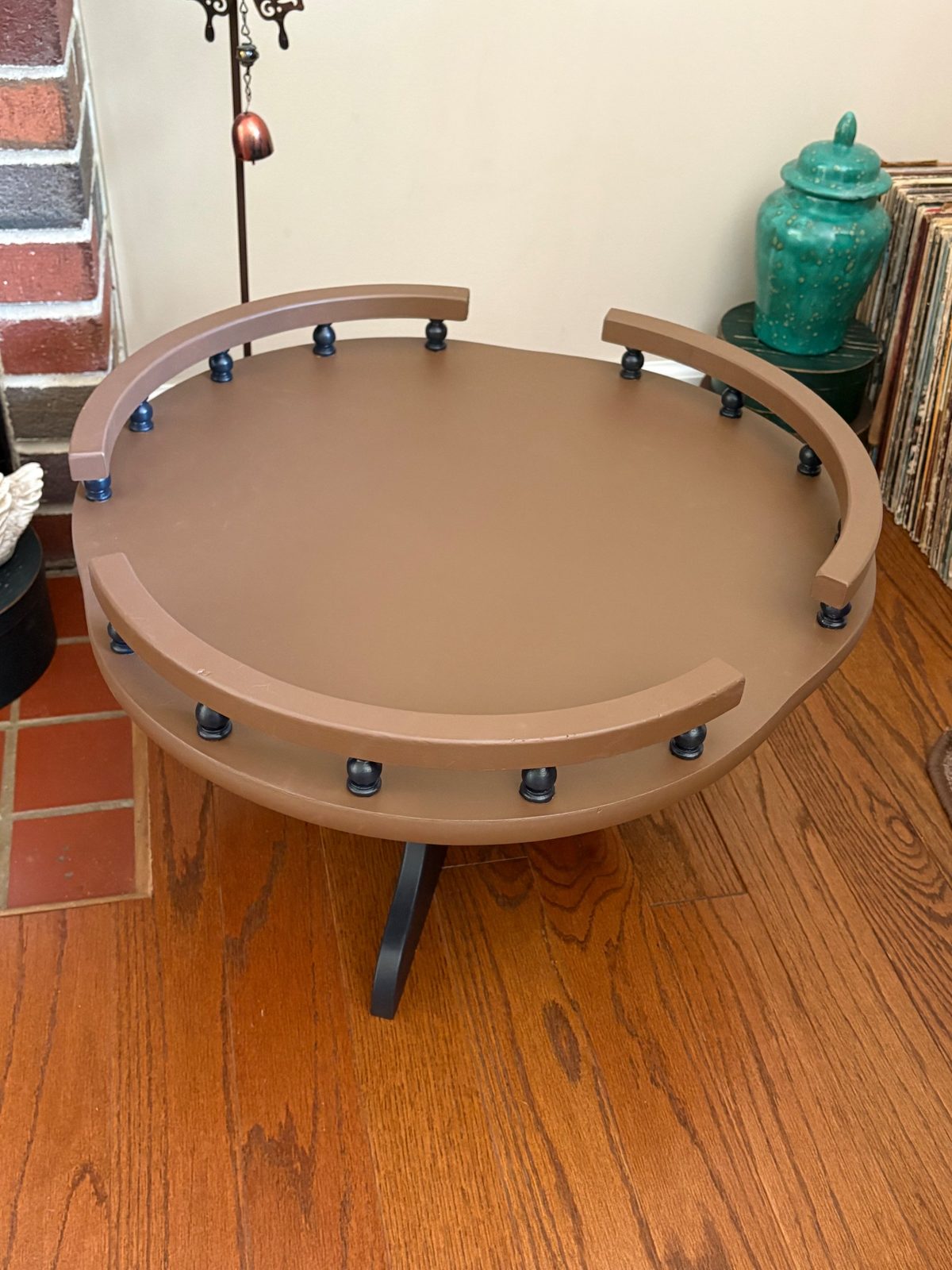 Upper tier of the refinished table: curved brown rails on dark turned spindles